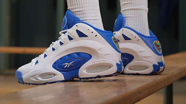 Side view of Emmitt Smith's blue and white Reebok sneakers.